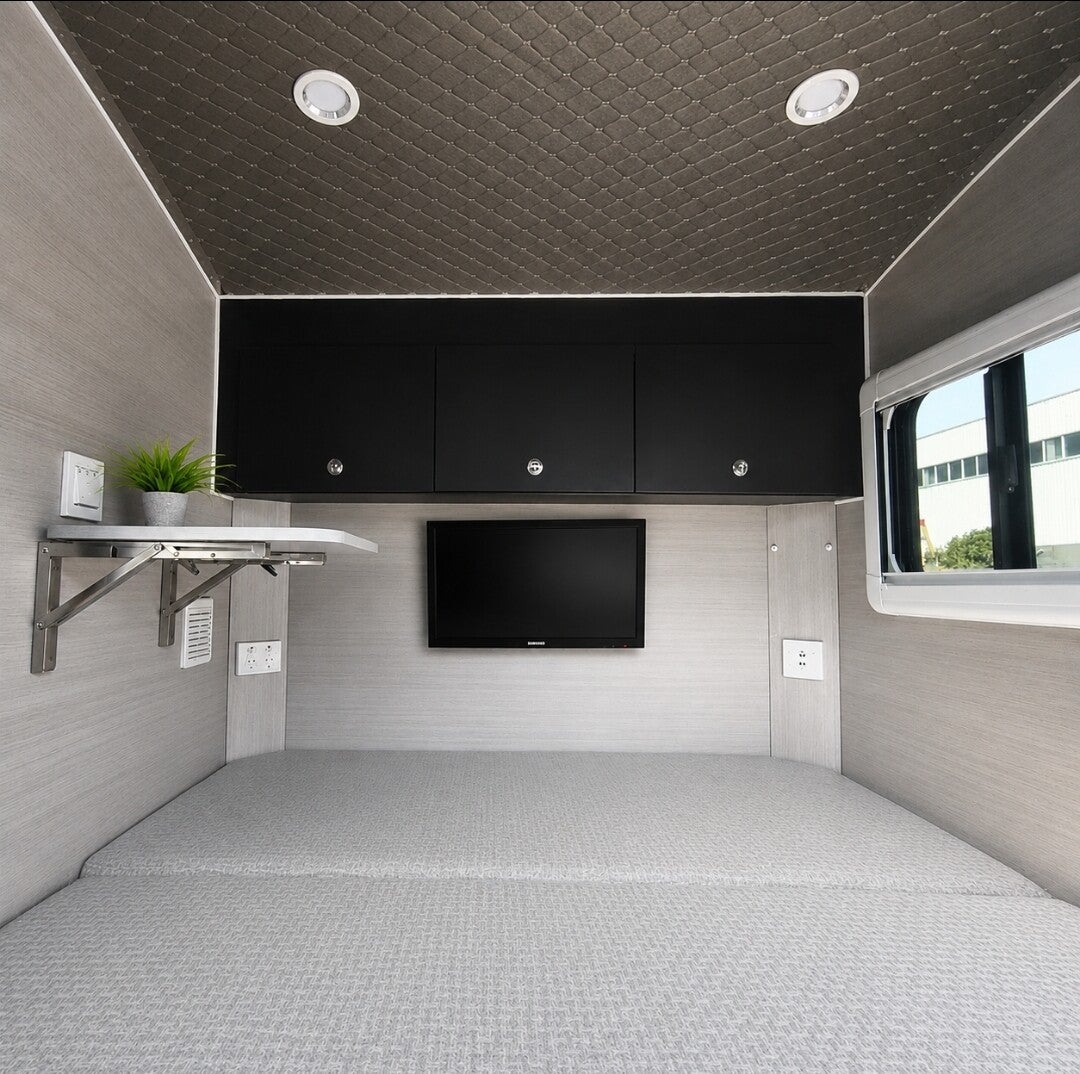 Sleeping cabin with overhead storage